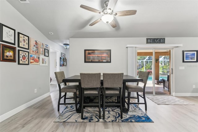 dining area featuring wood finished floors, a ceiling fan, and baseboards