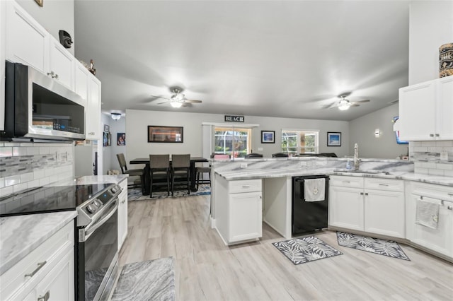 kitchen featuring light wood finished floors, appliances with stainless steel finishes, a ceiling fan, white cabinetry, and a peninsula