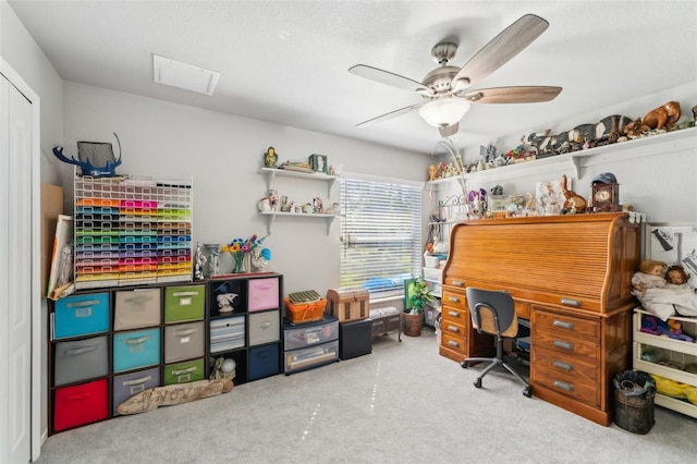 carpeted home office featuring a ceiling fan