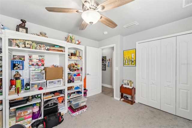 playroom featuring ceiling fan, carpet floors, visible vents, and baseboards