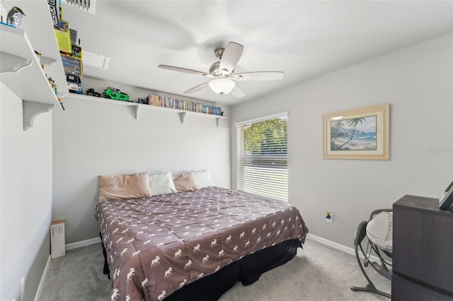 carpeted bedroom featuring visible vents, a ceiling fan, and baseboards