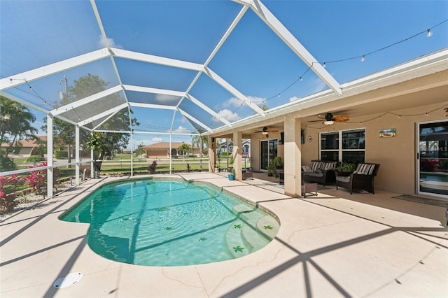 outdoor pool with a ceiling fan, a lanai, a patio, and an outdoor hangout area