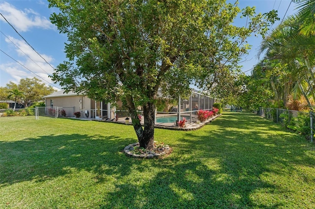 view of yard featuring a fenced backyard, a fenced in pool, and a lanai