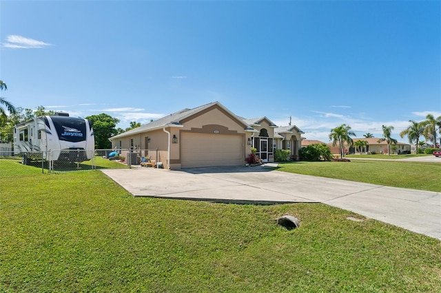 view of front of home with a garage, fence, driveway, stucco siding, and a front yard