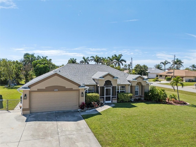 single story home with concrete driveway, a front lawn, an attached garage, and stucco siding