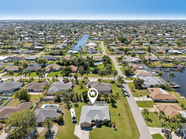 drone / aerial view with a water view and a residential view