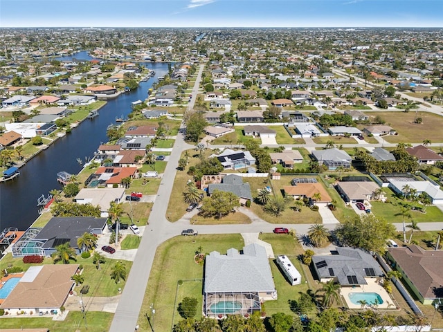 drone / aerial view with a residential view and a water view