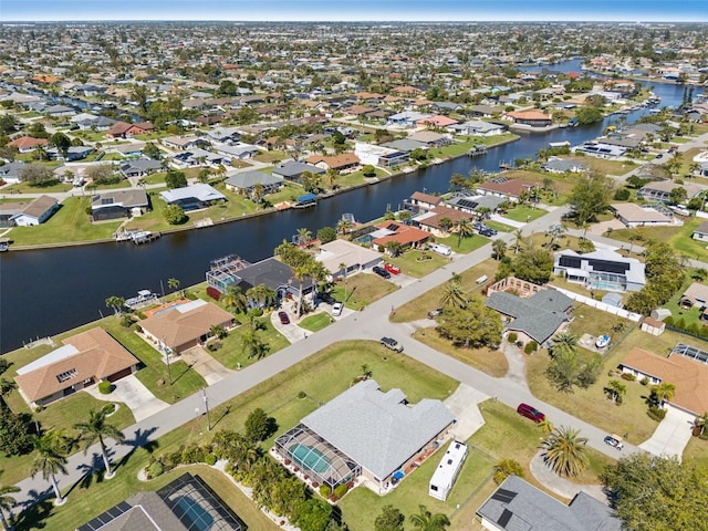 drone / aerial view with a residential view and a water view