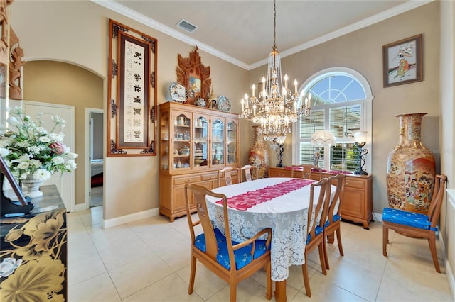 dining space featuring ornamental molding, arched walkways, visible vents, and light tile patterned floors