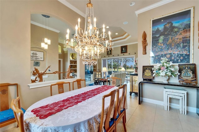 tiled dining area featuring a raised ceiling, crown molding, and baseboards