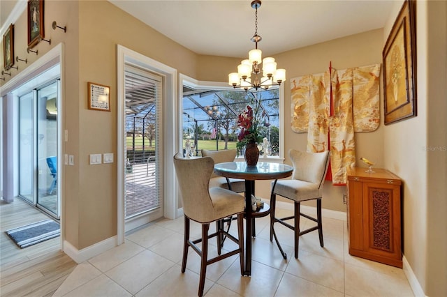 dining room featuring a chandelier, light tile patterned floors, and baseboards