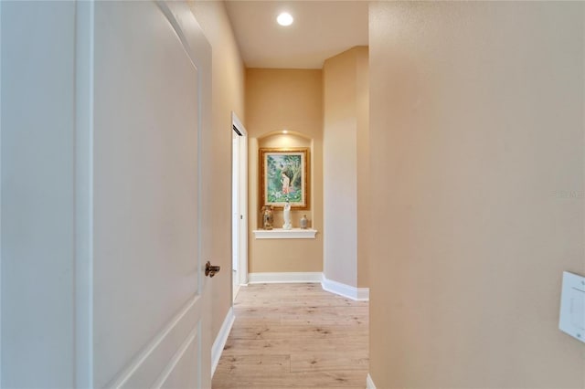 hallway with light wood finished floors, recessed lighting, and baseboards