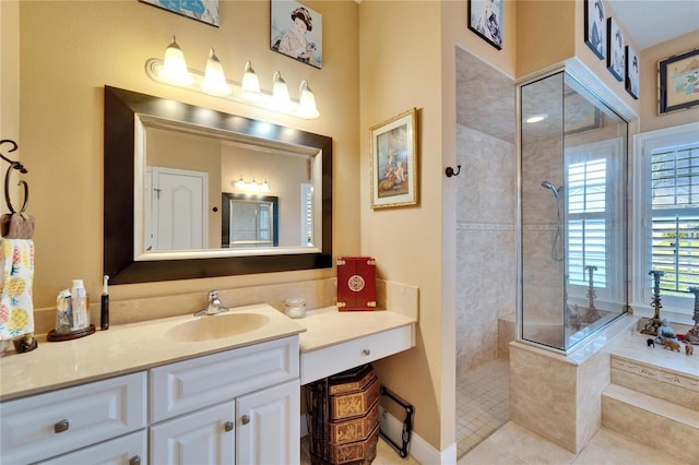 bathroom featuring tile patterned floors, vanity, baseboards, and a walk in shower