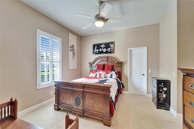 bedroom with light carpet, a ceiling fan, and baseboards