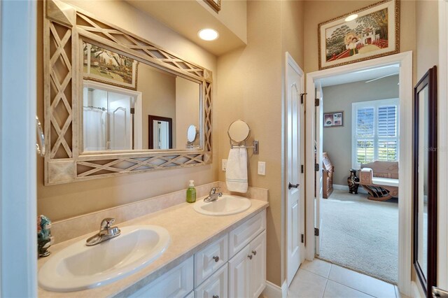 bathroom featuring double vanity, a sink, ensuite bath, and tile patterned floors