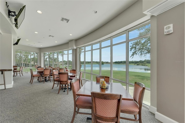 sunroom / solarium featuring a water view and visible vents