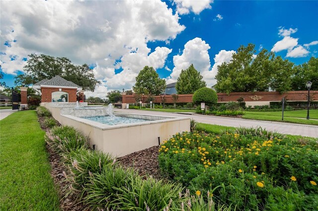 view of swimming pool with a yard