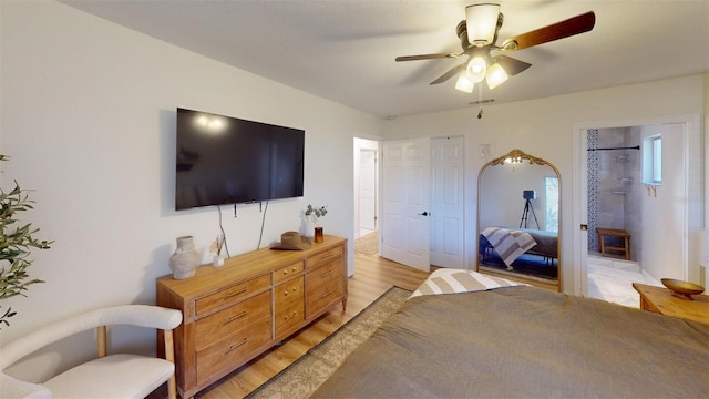 bedroom with light wood-style floors, visible vents, and a ceiling fan