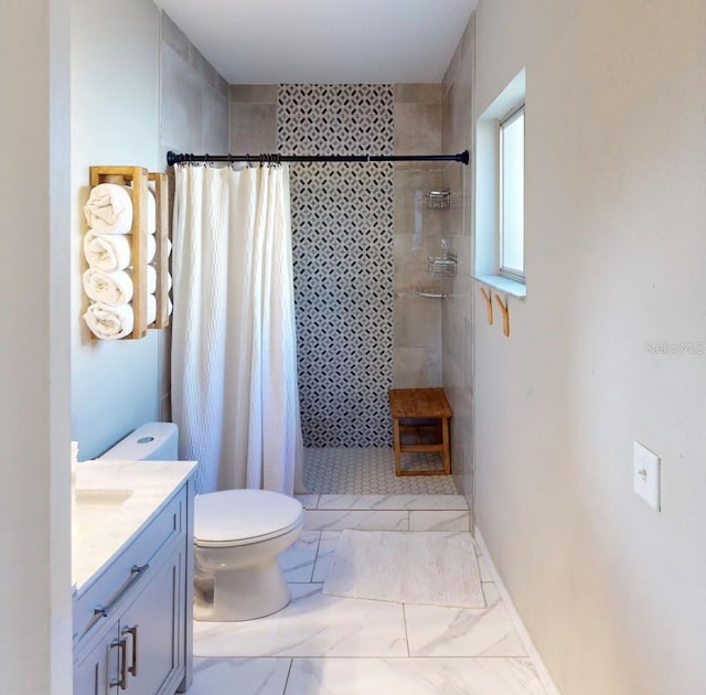 full bathroom featuring toilet, vanity, baseboards, marble finish floor, and a tile shower