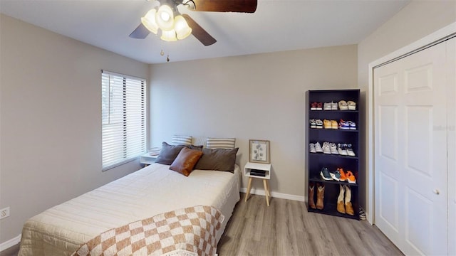 bedroom featuring wood finished floors, a ceiling fan, and baseboards