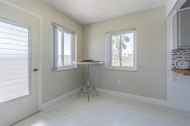 interior space with wood finished floors and baseboards