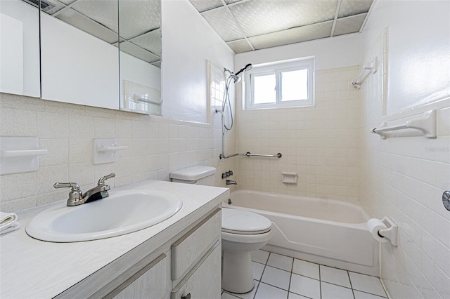 full bathroom featuring shower / bath combination, toilet, tile patterned flooring, vanity, and tile walls