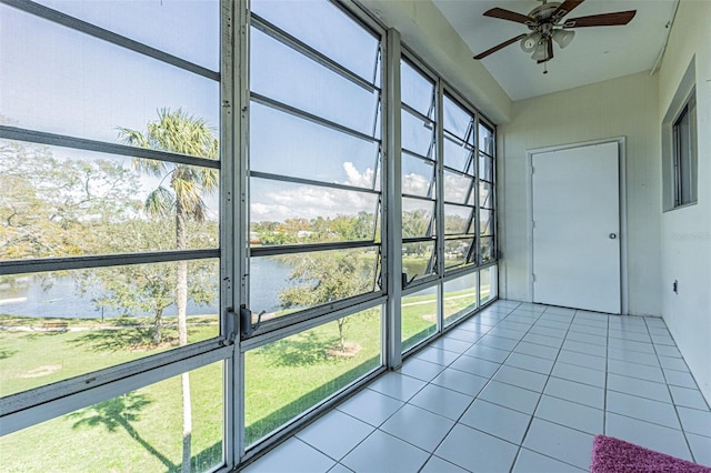 unfurnished sunroom featuring ceiling fan and a wealth of natural light