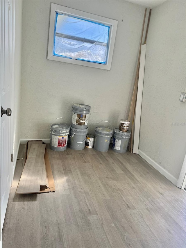 interior space with baseboards and wood finished floors