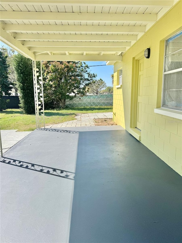 view of patio / terrace featuring a carport and fence