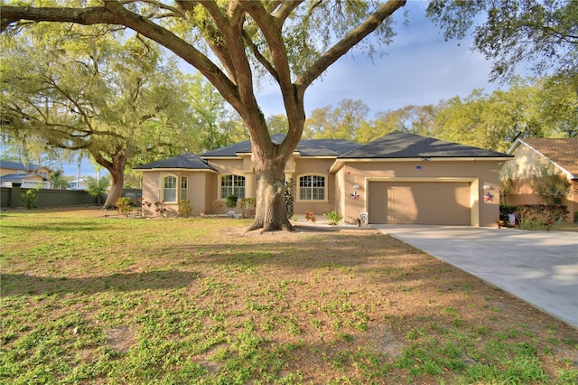 ranch-style home featuring a garage, a front lawn, concrete driveway, and stucco siding