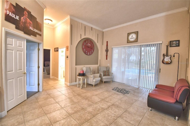 sitting room featuring light tile patterned floors, baseboards, and crown molding