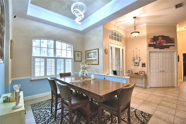 dining room with light tile patterned floors, visible vents, and crown molding