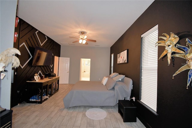 bedroom with a ceiling fan and light wood-style flooring