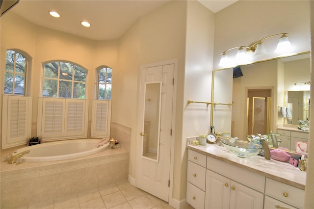 full bathroom with a garden tub, vanity, a stall shower, and tile patterned floors