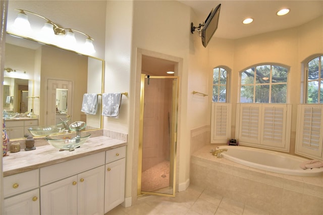 bathroom featuring a stall shower, a garden tub, tile patterned flooring, vanity, and recessed lighting