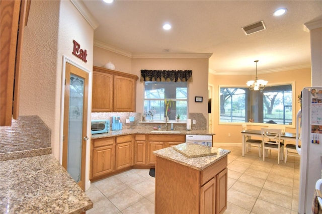 kitchen featuring white appliances, a sink, a healthy amount of sunlight, ornamental molding, and backsplash