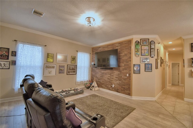 living area with brick wall, visible vents, and crown molding