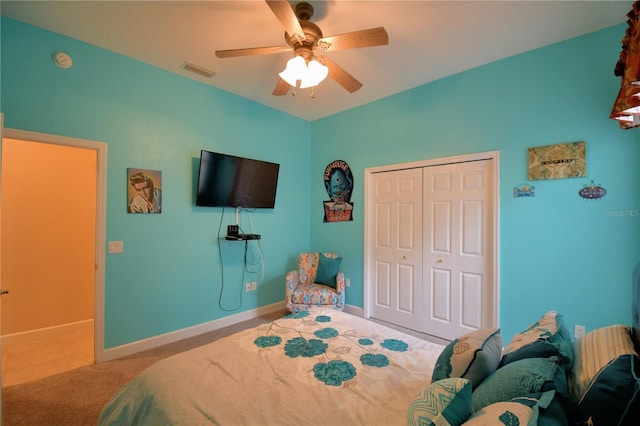 carpeted bedroom featuring baseboards, visible vents, ceiling fan, and a closet