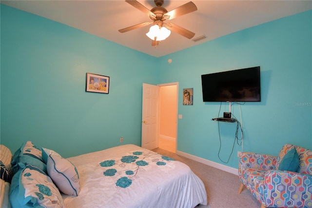 carpeted bedroom featuring visible vents, baseboards, and ceiling fan