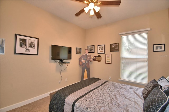 carpeted bedroom featuring ceiling fan and baseboards