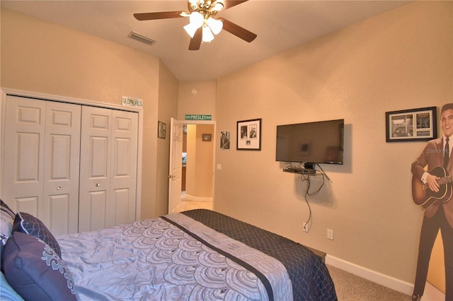 carpeted bedroom with a ceiling fan, a closet, visible vents, and baseboards