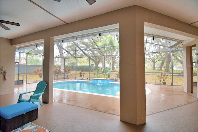 view of swimming pool featuring a ceiling fan and a fenced in pool