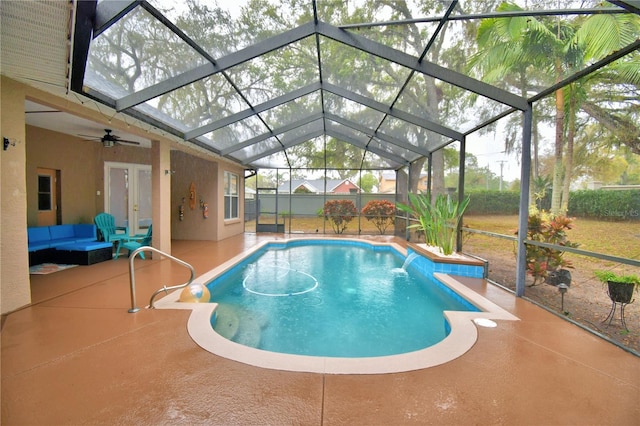 outdoor pool featuring outdoor lounge area, french doors, a patio area, and a lanai