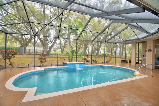 outdoor pool with glass enclosure and a patio