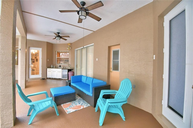 view of patio featuring a ceiling fan, an outdoor living space, and area for grilling