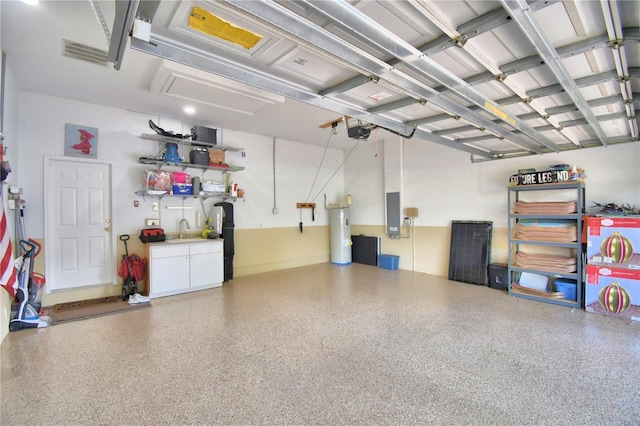 garage featuring water heater, a sink, visible vents, and a garage door opener