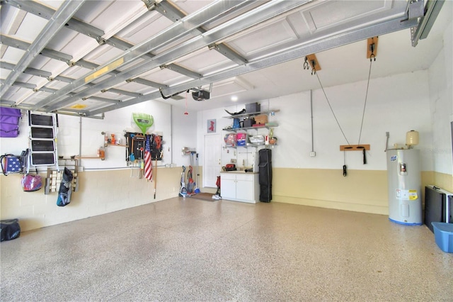 garage with a garage door opener and electric water heater