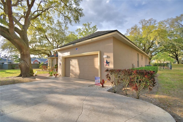 view of home's exterior featuring concrete driveway, an attached garage, and stucco siding