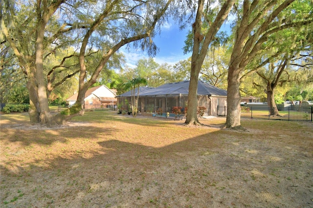 view of yard featuring a lanai and fence