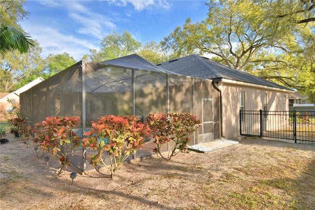 view of side of home featuring a lanai and fence